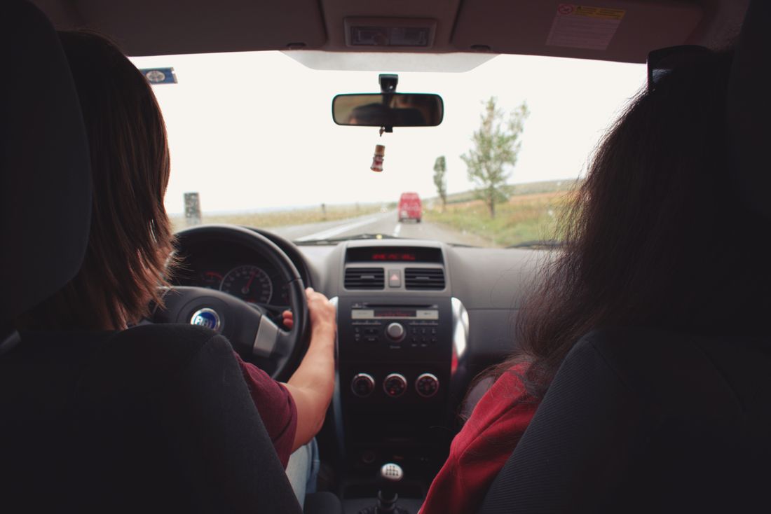 A driving lesson in progress seen from the rear seats