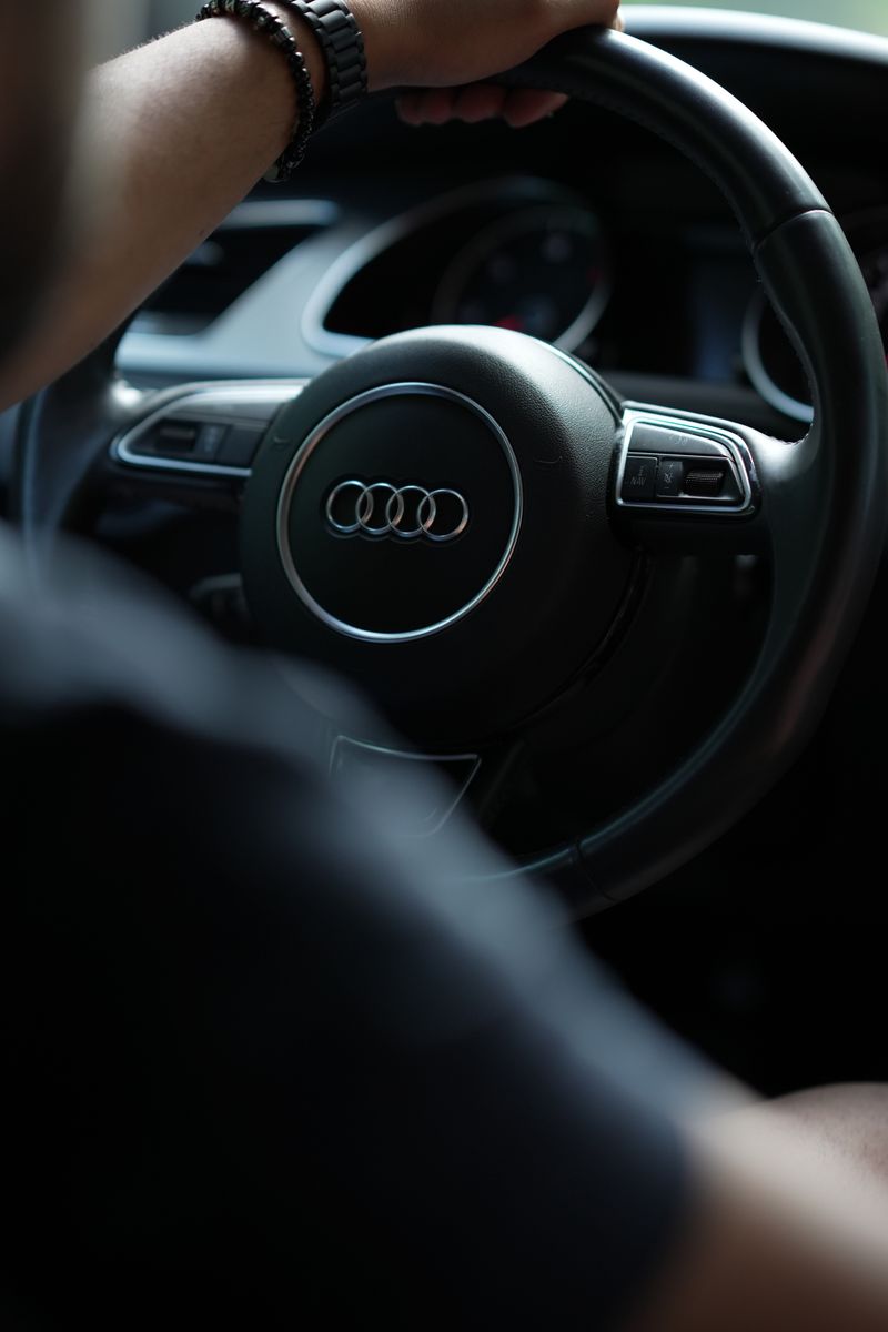 Driver's hands on the wheel of a car
