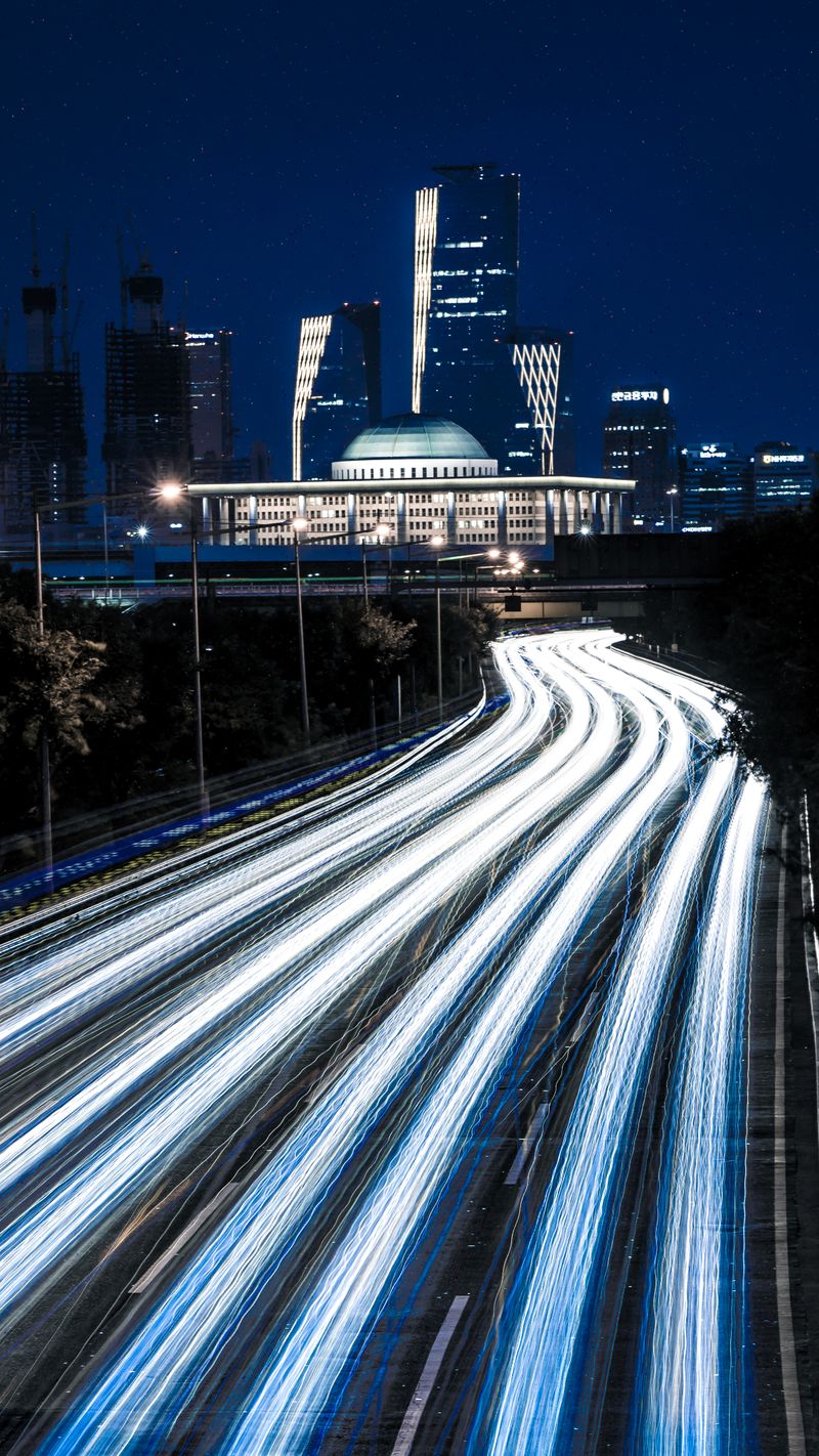 Light trails from traffic on a road at night