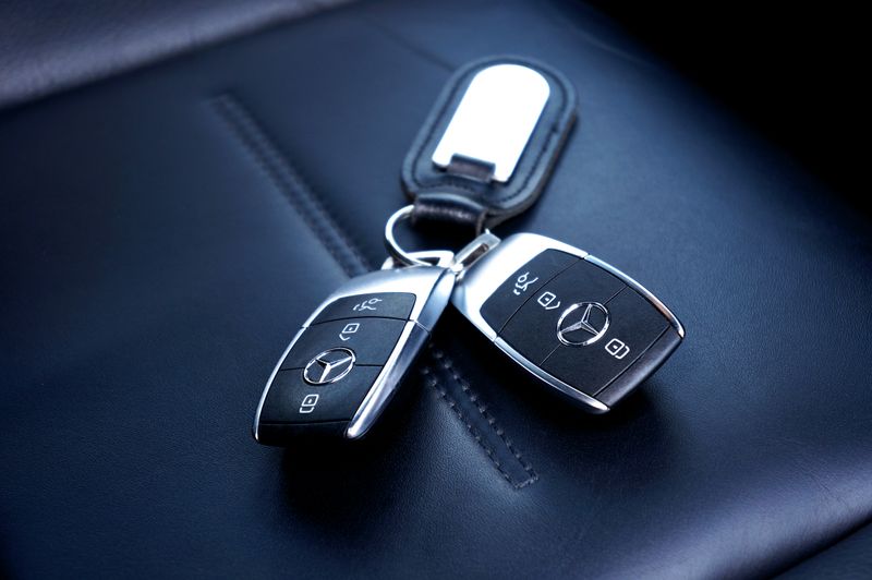 A set of car keys resting on a leather seat