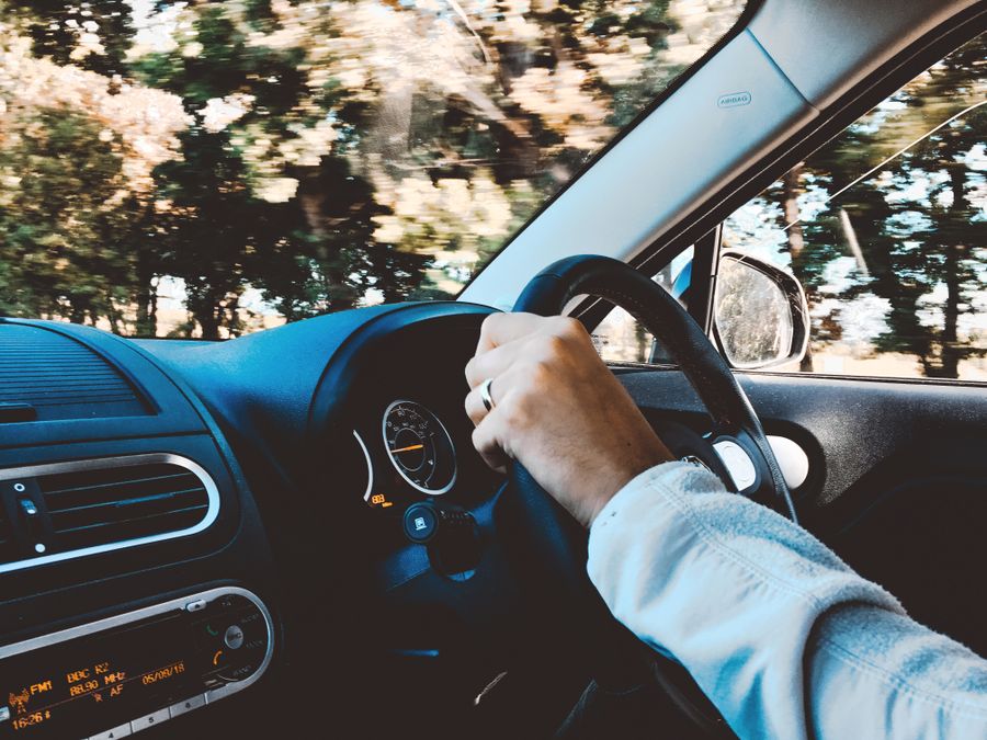 A learner's hands positioned correctly on the steering wheel