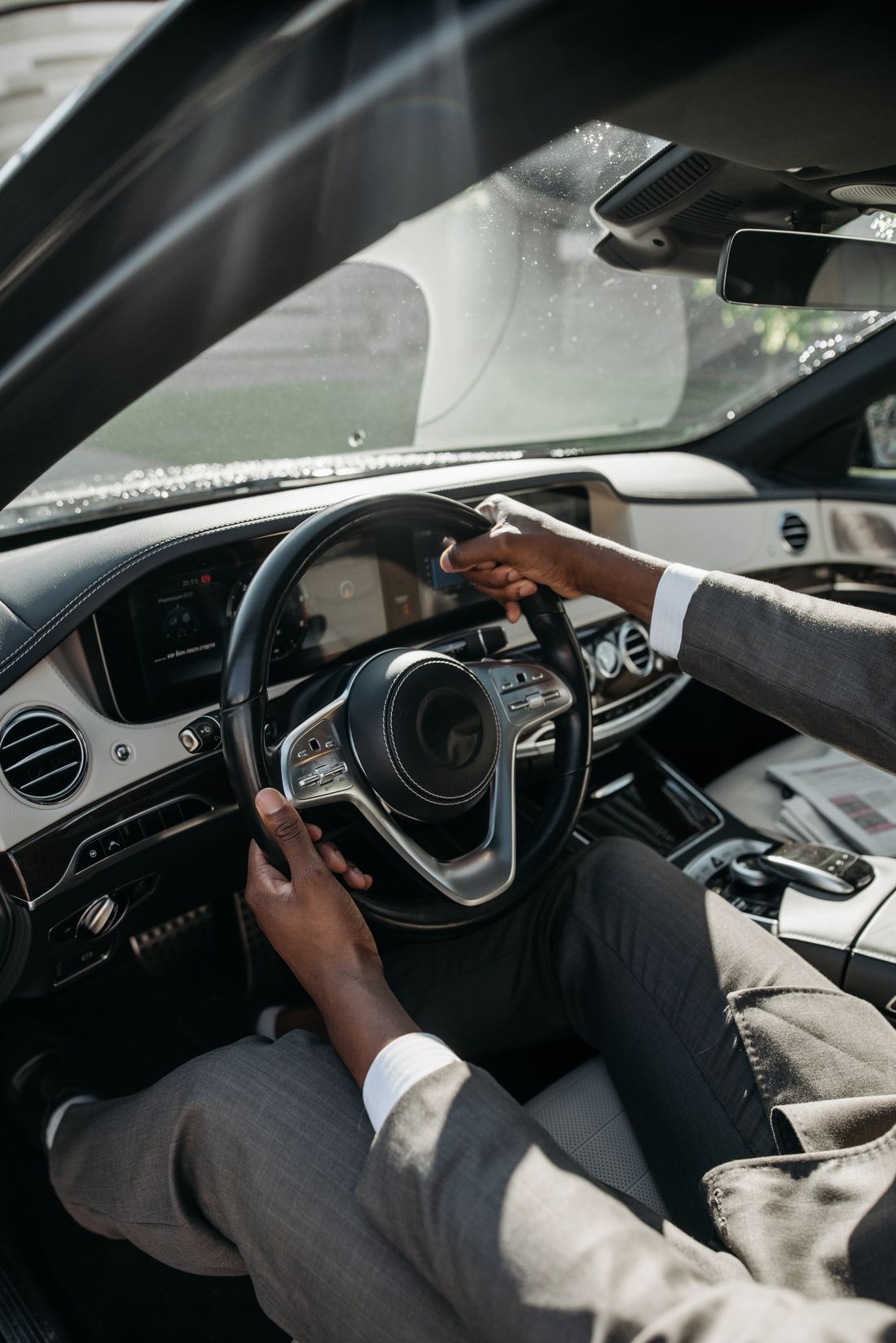 Confident hands on the steering wheel of a car